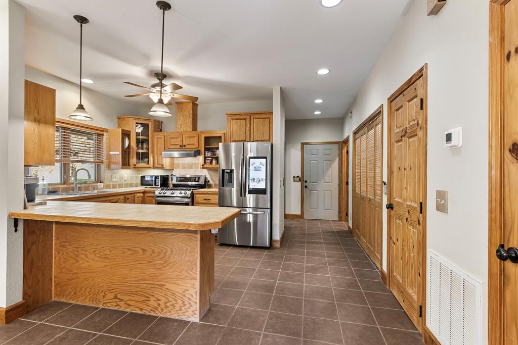 297 Lovingood Road Marble, NC 28905 - Photo 12 of 91 a view of a kitchen with kitchen island stainless steel appliances refrigerator stove and furniture
