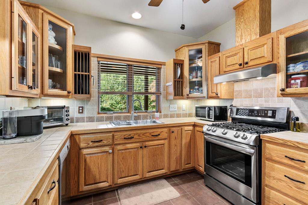 297 Lovingood Road Marble, NC 28905 - Photo 14 of 91 a kitchen with stainless steel appliances granite countertop a stove and a sink