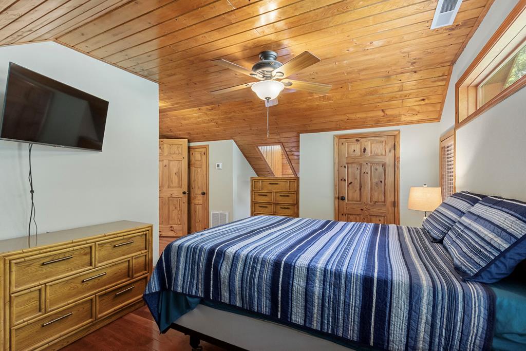 297 Lovingood Road Marble, NC 28905 - Photo 39 of 91 a bedroom with a bed and a chandelier