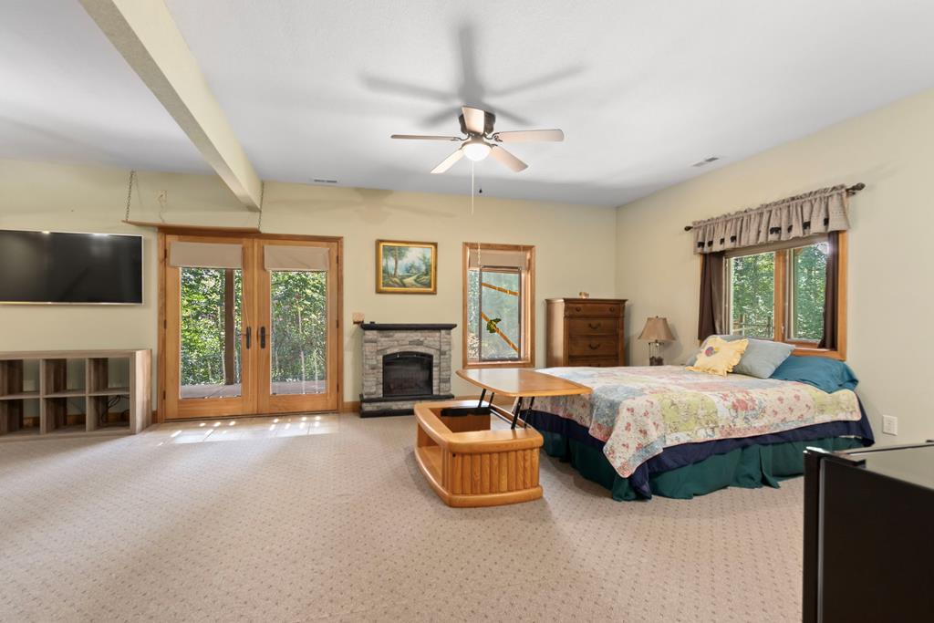 297 Lovingood Road Marble, NC 28905 - Photo 47 of 91 a spacious bedroom with a bed and a fireplace