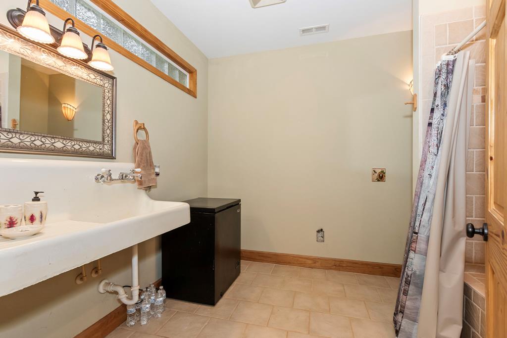 297 Lovingood Road Marble, NC 28905 - Photo 53 of 91 a bathroom with a sink vanity and a mirror