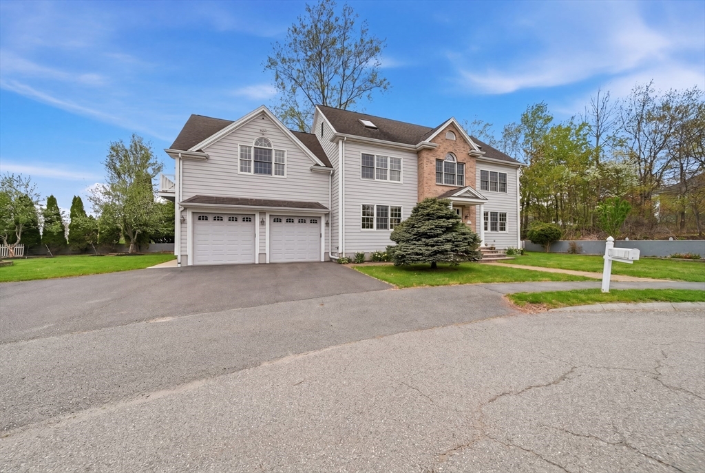 131 Range Heights Road Lynn, MA 01904 - Photo 2 of 36 a front view of a house with a yard and garage