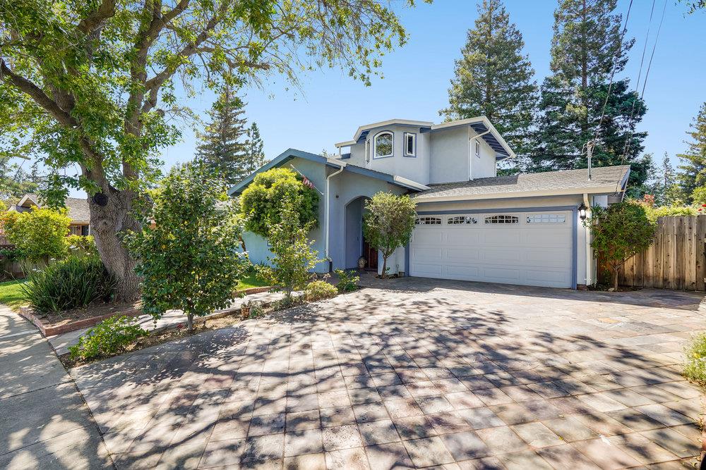 a view of a house with a yard and garage