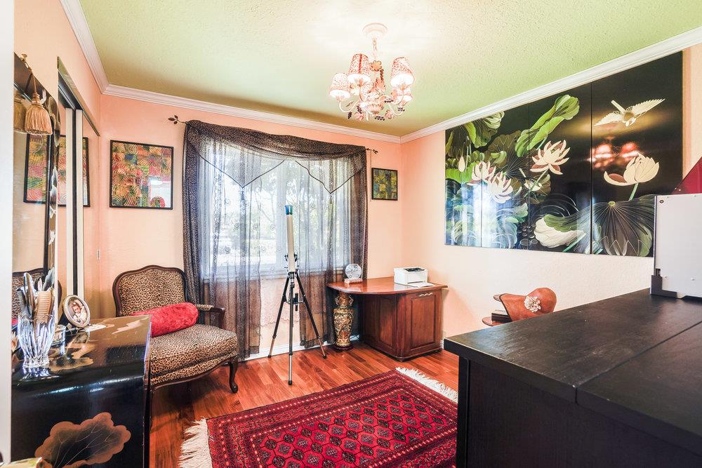1893 Anthony Court Mountain View, CA 94040 - Photo 9 of 38 a living room with furniture a chandelier and a fireplace
