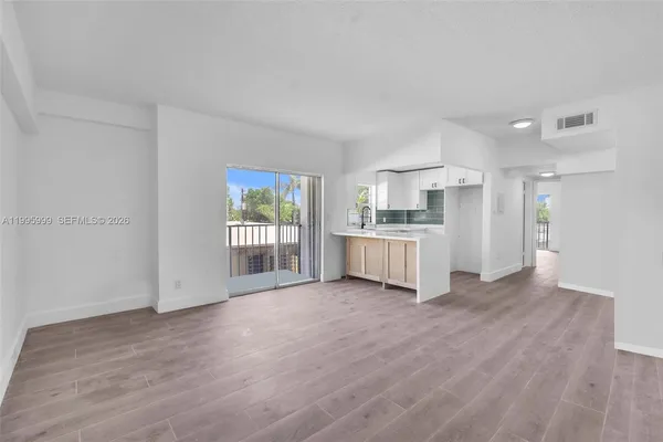 a view of a kitchen with a sink cabinets and a wooden floor