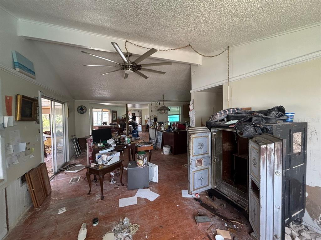 4447 Bahama Drive Hernando Beach, FL 34607 - Photo 12 of 31 a living room with furniture a fireplace a flat screen tv and a window
