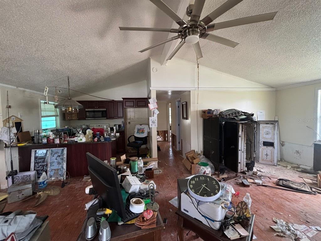 4447 Bahama Drive Hernando Beach, FL 34607 - Photo 13 of 31 a living room with lots of furniture and gym equipment