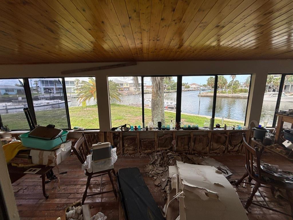 4447 Bahama Drive Hernando Beach, FL 34607 - Photo 14 of 31 a living room with furniture and large windows