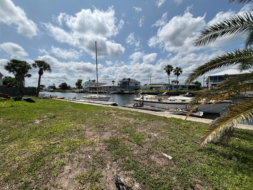 4447 Bahama Drive Hernando Beach, FL 34607 - Photo 17 of 31 a view of a swimming pool with an outdoor seating and a yard