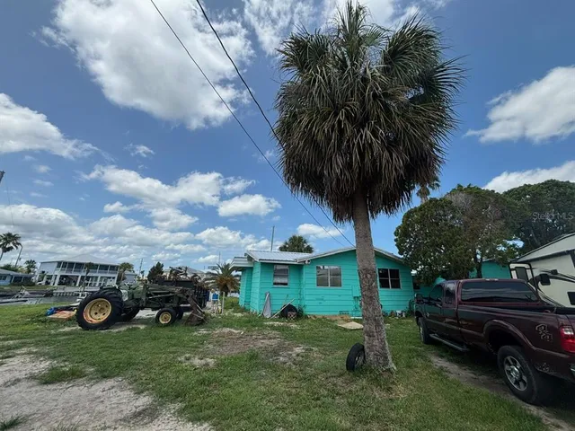 an aerial view of a house with a yard