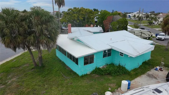 an aerial view of a house with a yard swimming pool and outdoor seating