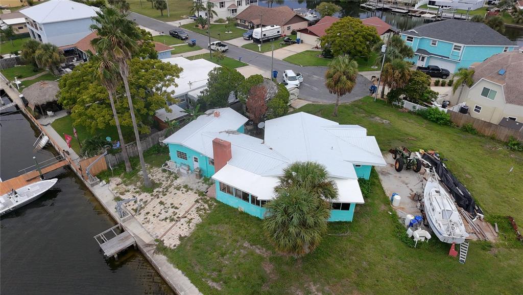 4447 Bahama Drive Hernando Beach, FL 34607 - Photo 26 of 31 an aerial view of a house with a garden and lake view