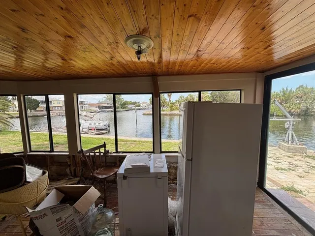 a living room with furniture and large windows