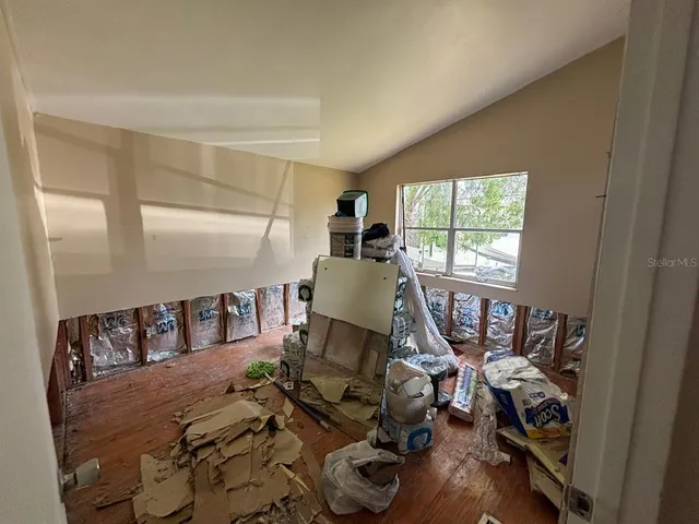 a living room with furniture a fireplace a flat screen tv and a window