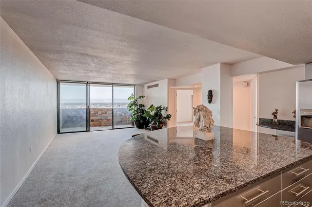 a view of a living room and kitchen view