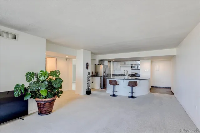 a kitchen with stainless steel appliances kitchen island granite countertop a stove and a sink
