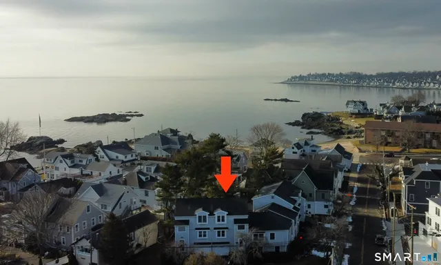an aerial view of a house with a lake