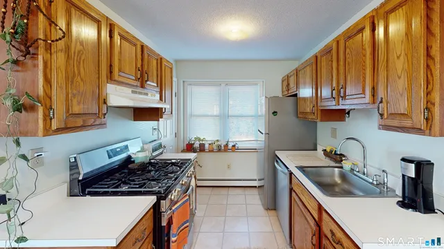 a kitchen with a sink a stove and cabinets