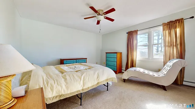 a bedroom with a bed and a couch