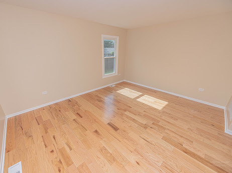 7 Boulder Ridge Court Bolingbrook, IL 60490 - Photo 12 of 44 a view of empty room with wooden floor and fan