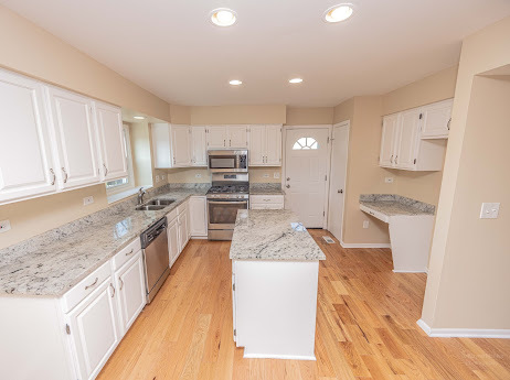 7 Boulder Ridge Court Bolingbrook, IL 60490 - Photo 21 of 44 a kitchen with stainless steel appliances granite countertop a stove a sink and a refrigerator