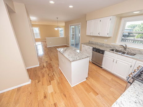 7 Boulder Ridge Court Bolingbrook, IL 60490 - Photo 22 of 44 a kitchen with granite countertop a sink stove and cabinets