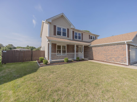 7 Boulder Ridge Court Bolingbrook, IL 60490 - Photo 3 of 44 a front view of a house with a yard and garage