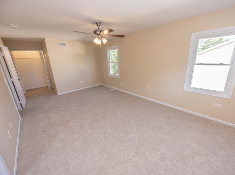 7 Boulder Ridge Court Bolingbrook, IL 60490 - Photo 32 of 44 an empty room with windows and chandelier fan