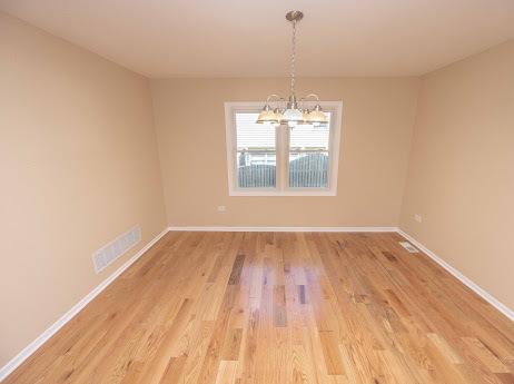 7 Boulder Ridge Court Bolingbrook, IL 60490 - Photo 8 of 44 a view of empty room with wooden floor and window
