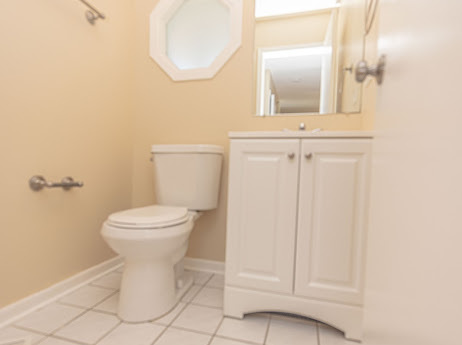 7 Boulder Ridge Court Bolingbrook, IL 60490 - Photo 9 of 44 a bathroom with a toilet and a mirror