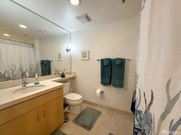 a bathroom with a sink toilet and mirror