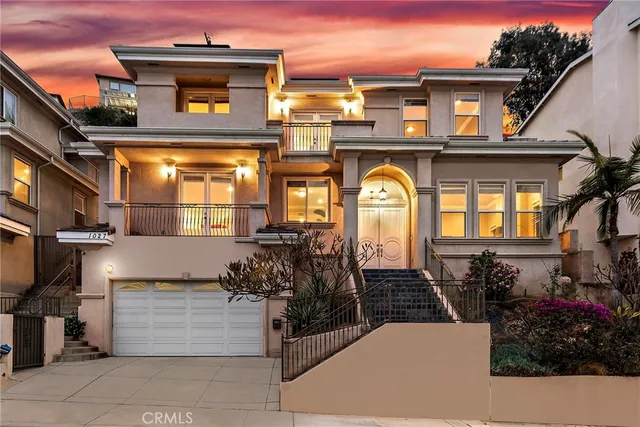 a front view of a house with a garden
