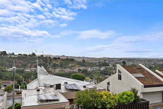 an aerial view of residential houses with outdoor space and ocean