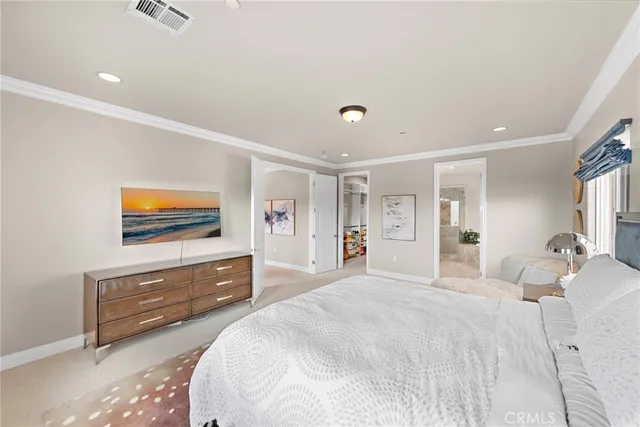 a spacious bedroom with a bed and a dresser