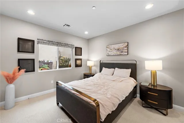 a bedroom with a large bed and a tv