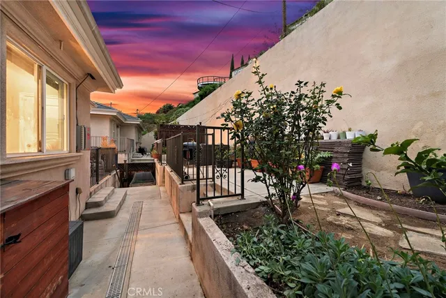 a view of a porch with chairs and potted plants