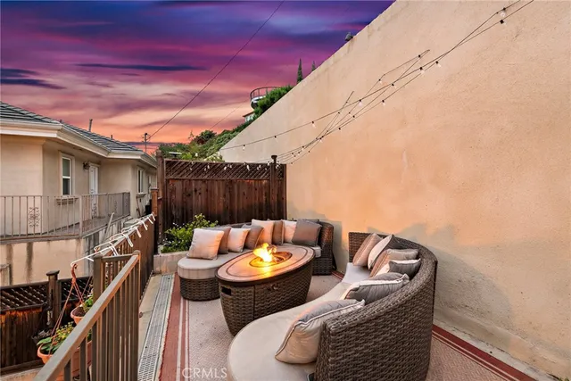 a backyard of a house with table and chairs