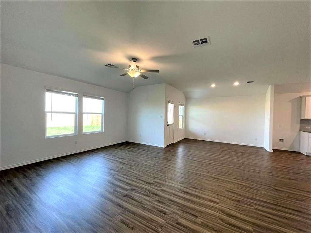 409 Bluejack Way Hutto, TX 78634 - Photo 10 of 28 an empty room with wooden floor and window