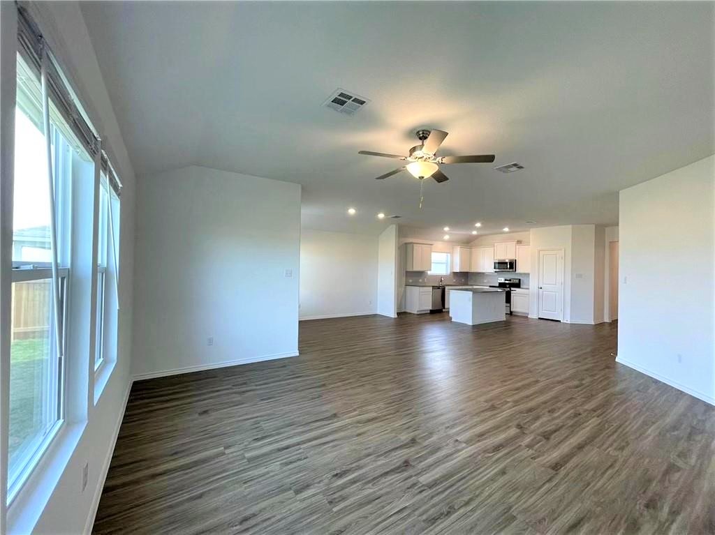 409 Bluejack Way Hutto, TX 78634 - Photo 11 of 28 a view of kitchen and hall with wooden floor