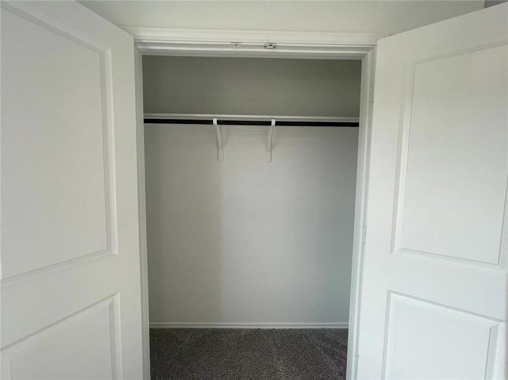 409 Bluejack Way Hutto, TX 78634 - Photo 13 of 28 a view of walk in closet with empty racks