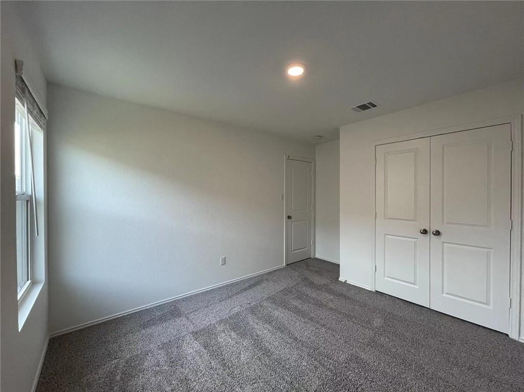 409 Bluejack Way Hutto, TX 78634 - Photo 16 of 28 a view of an empty room and a window