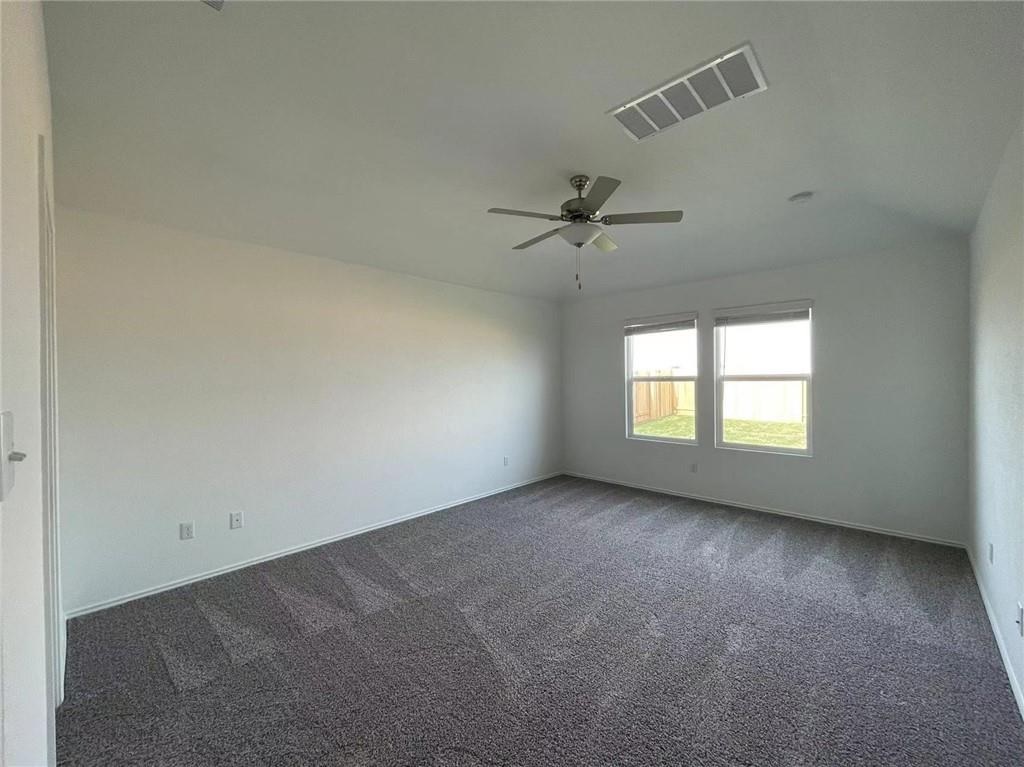 409 Bluejack Way Hutto, TX 78634 - Photo 26 of 28 an empty room with a empty space and windows