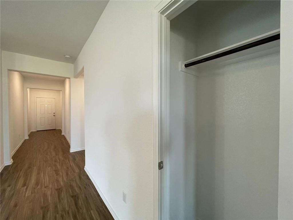 409 Bluejack Way Hutto, TX 78634 - Photo 27 of 28 a view of a hallway with wooden floor