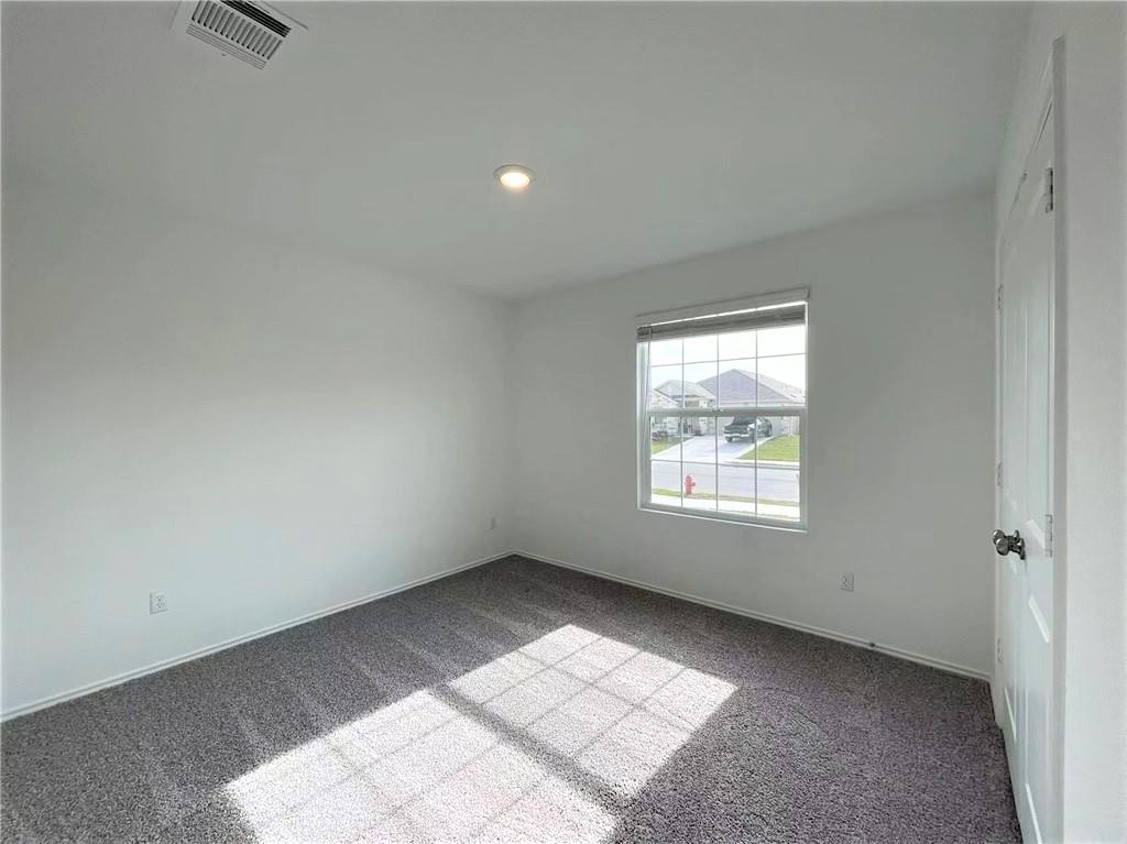 409 Bluejack Way Hutto, TX 78634 - Photo 6 of 28 an empty room with a window