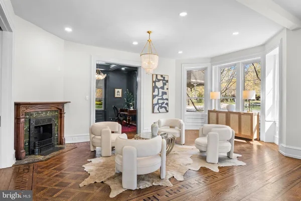 a view of a dining room with furniture a chandelier and wooden floor
