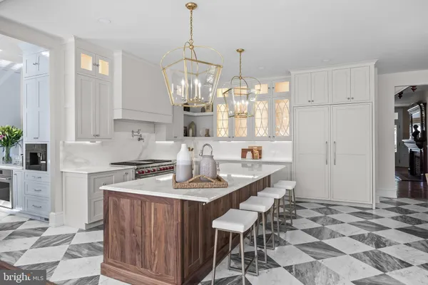 a living room with furniture a chandelier and a large window