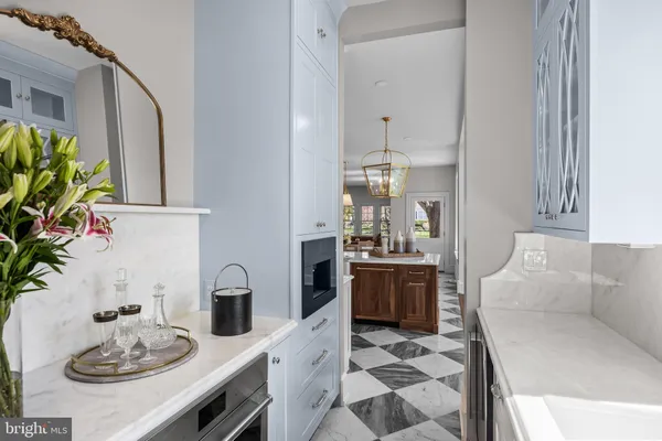 a living room with furniture a lamp wooden floor and a chandelier