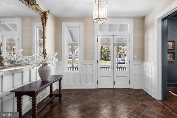 a living room with furniture a fireplace and a chandelier