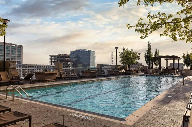 a view of a patio with table and chairs potted plants and a large tree