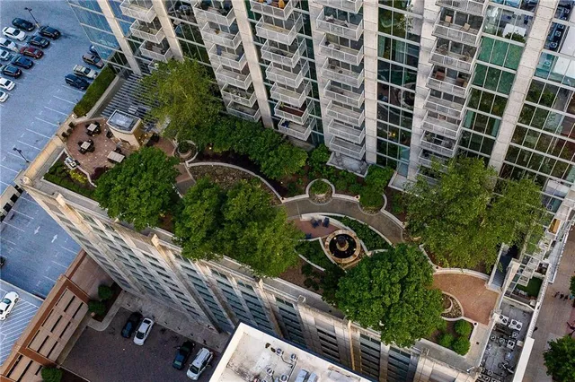 a living room with furniture ceiling fan and a large window